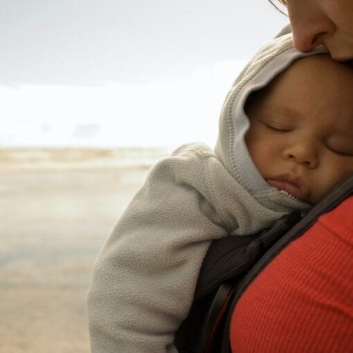 Mother With Baby Boy In Sling