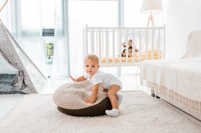 Adorable Toddler In White Nursery Room