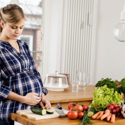 Pregnant Woman Chopping Vegetables