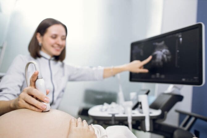 Cropped Shot Of A Pregnant Woman During Ultrasound Scanning At The Fertility Clinic.