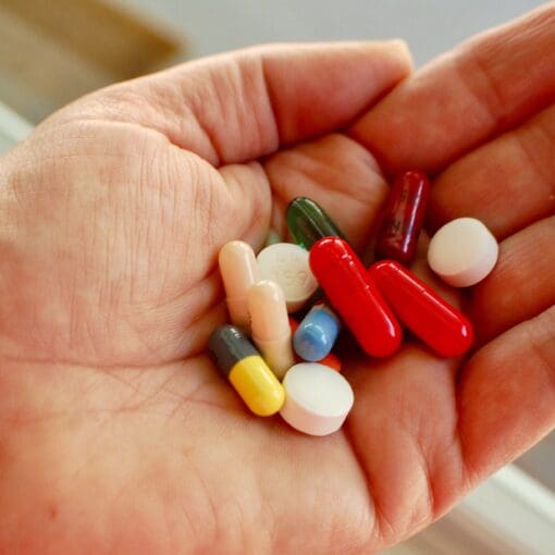 Hand Holding Various Medications
